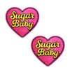 Two pink glitter heart-shaped patches with 'Sugar Baby' text on a white background