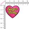 Heart-shaped patch with 'Sugar Baby' text on a white background, next to a ruler for scale.
