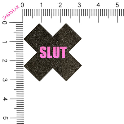 Black 'X' with 'SLUT' in pink on a white background with a ruler for scale.